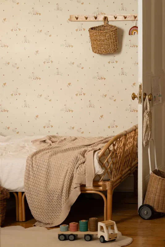 The Mallard Meadow wallpaper in buttermilk and beige behind the bed in a bedroom