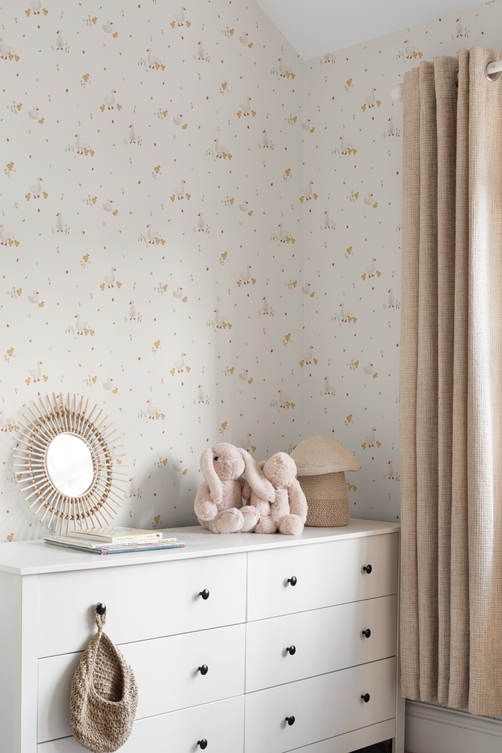 The Mallard Meadow wallpaper in buttermilk and beige behind a styled console