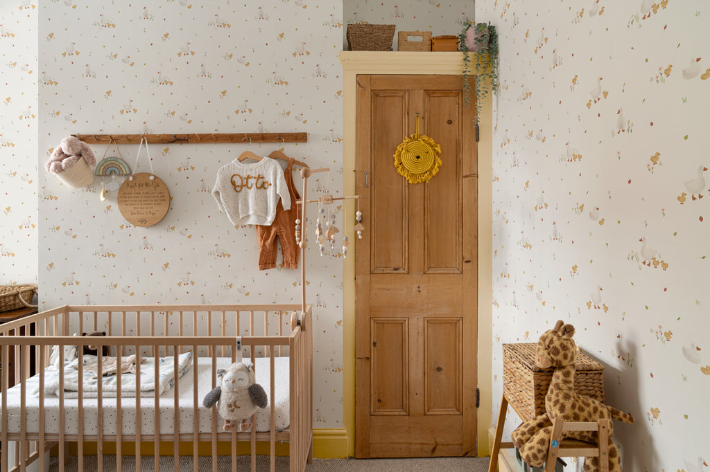 The Mallard Meadow wallpaper in buttermilk and beige on a nursery wall