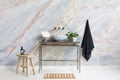 The Marble Fissure mural in pale stone and bronze in a bathroom
