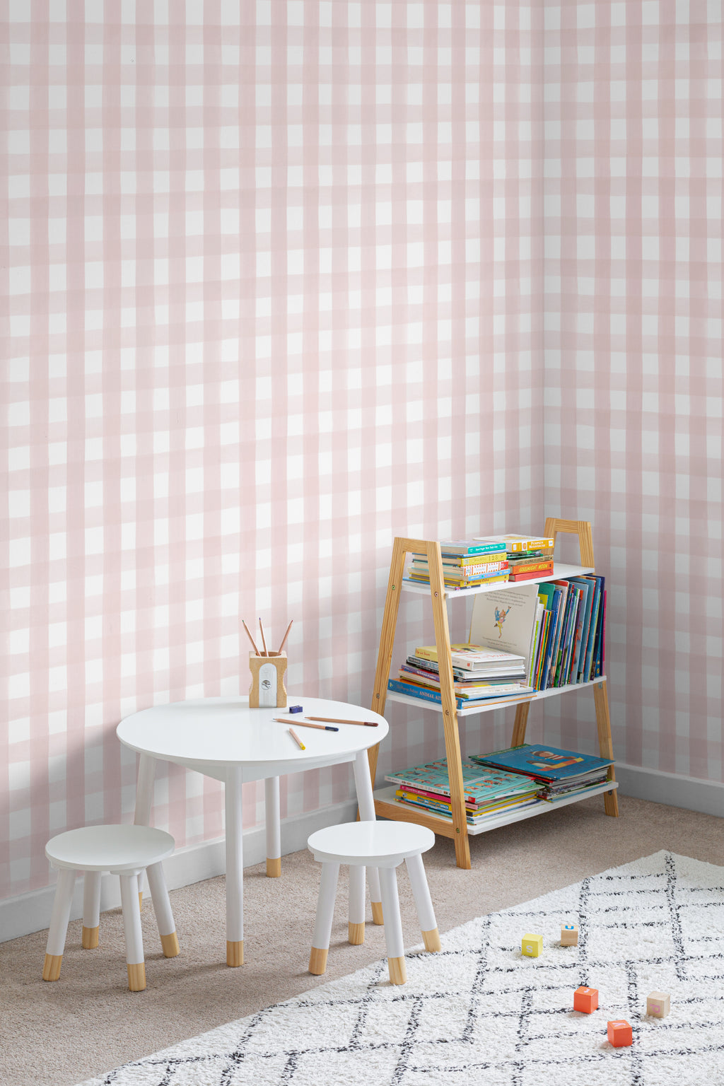 The Meadow Gingham wallpaper in ballet pink in a children's room setting