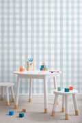 The Meadow Gingham wallpaper in powder blue on a nursery wall
