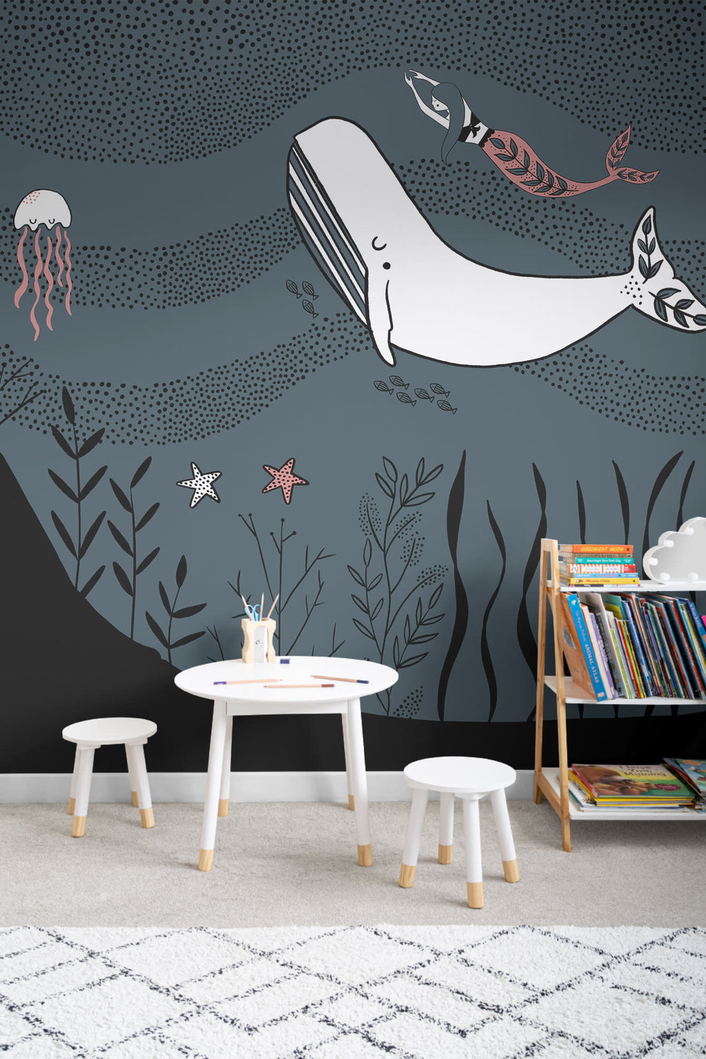 The Mermaid Grotto mural in deep ocean behind a kids' play corner