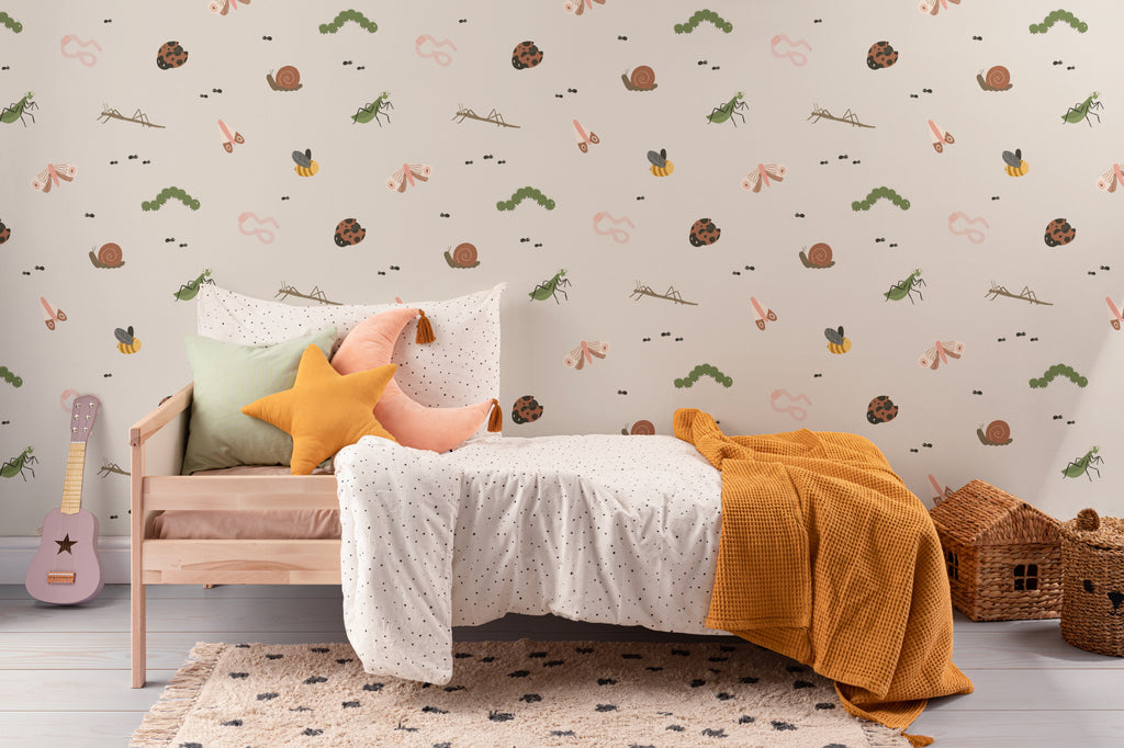The Minibeast Garden wallpaper in soft neutral behind a kids' play corner
