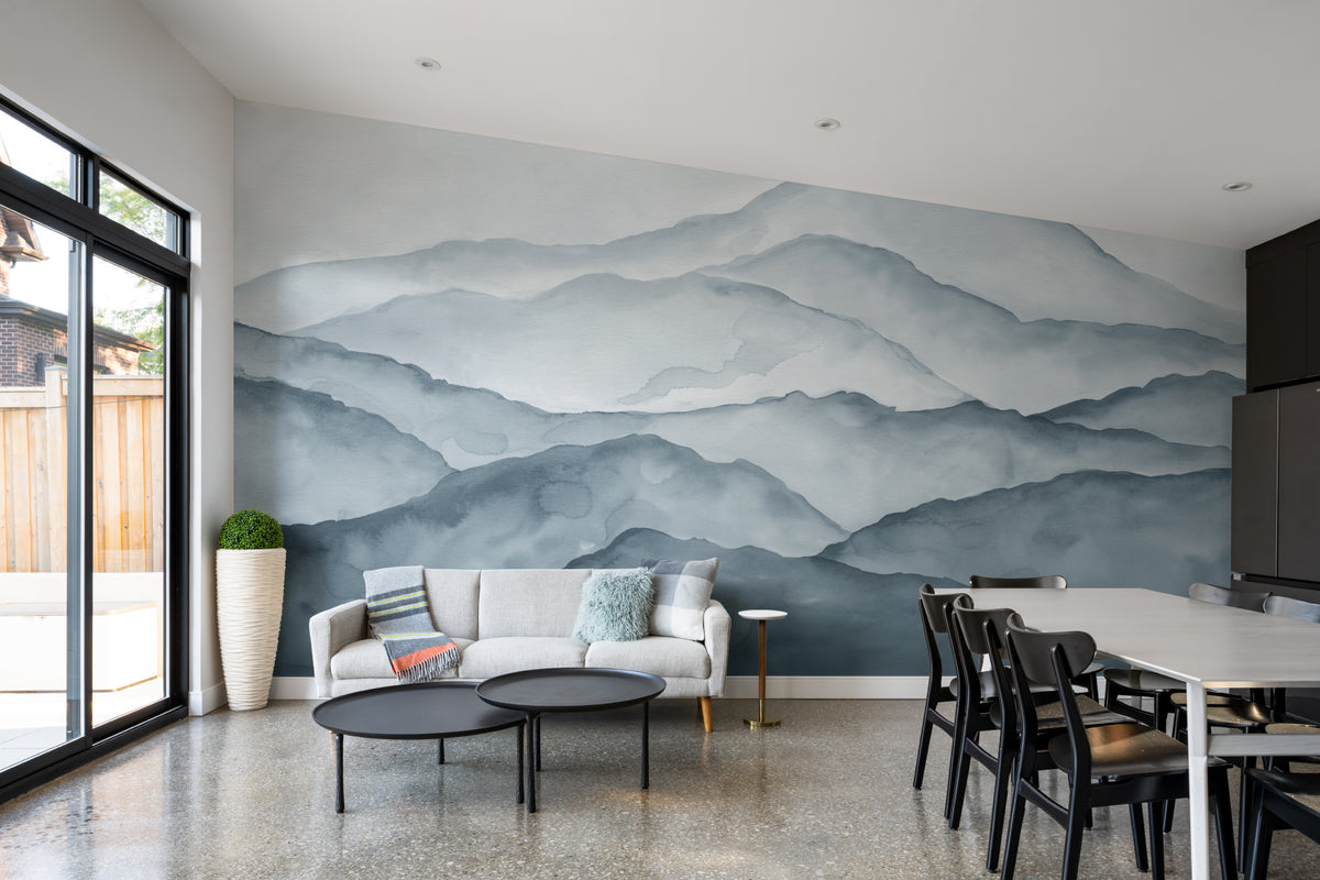 The Misted Ranges mural in ink and ice blue behind a dining table