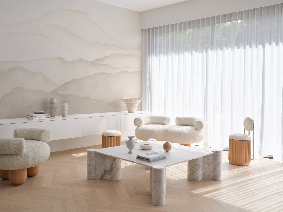 The Misted Ranges mural in sand and cream behind seating in a living room