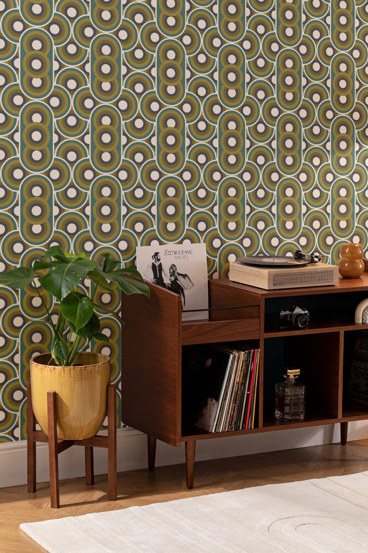 The Mod Portico wallpaper in olive and chocolate behind a styled console