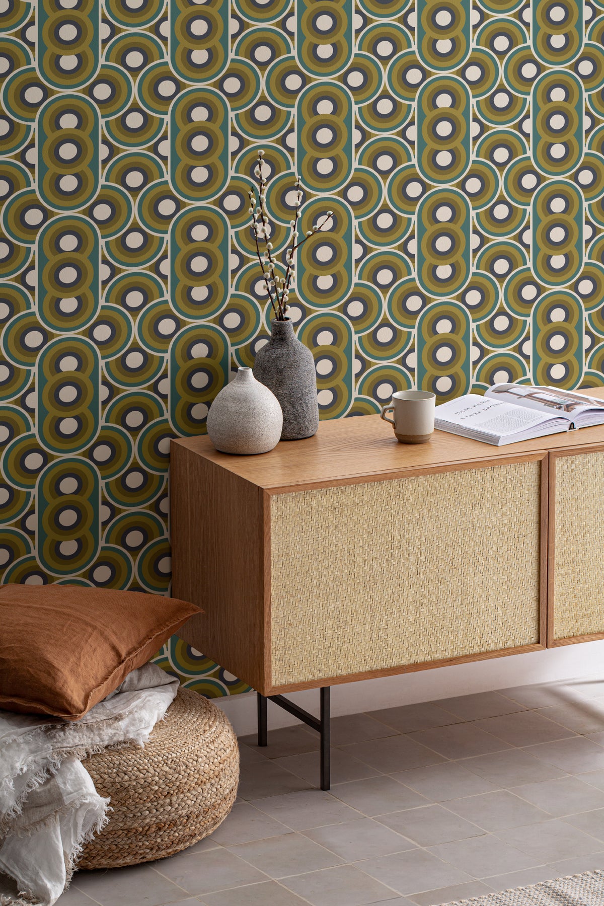 The Mod Portico wallpaper in olive and chocolate as a backdrop to styled furniture