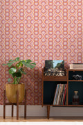 The Mod Portico wallpaper in tangerine and pink behind a styled console