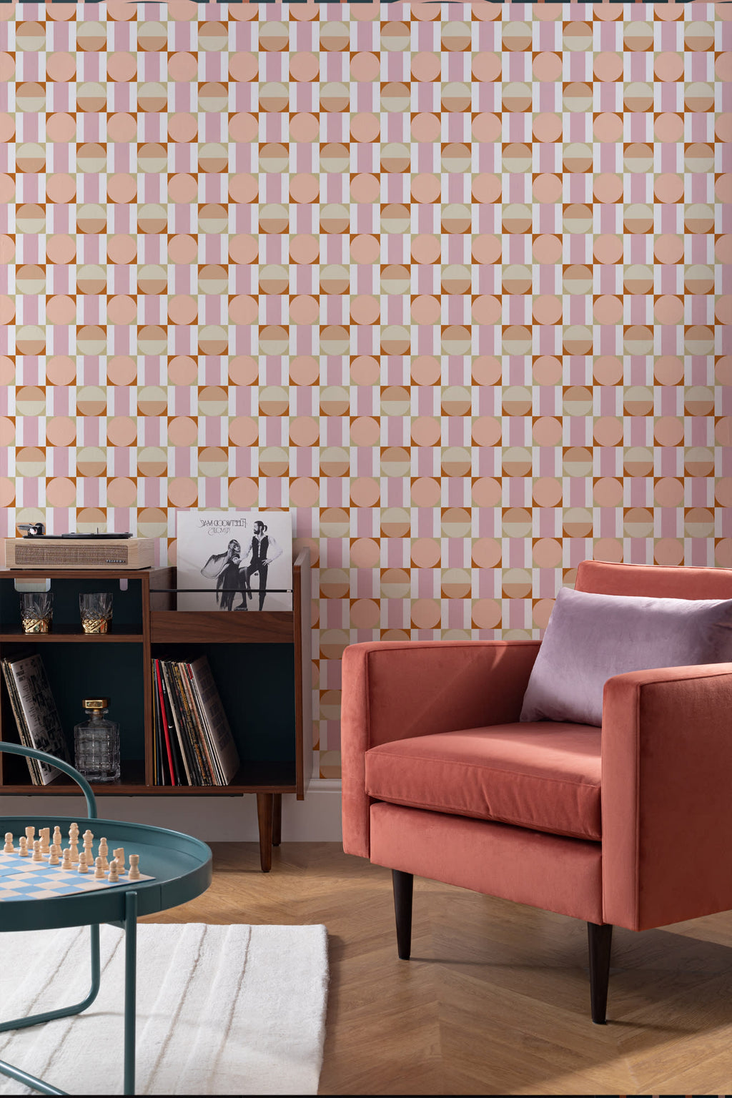 The Modernist Mosaic wallpaper in peach and rose in a living room