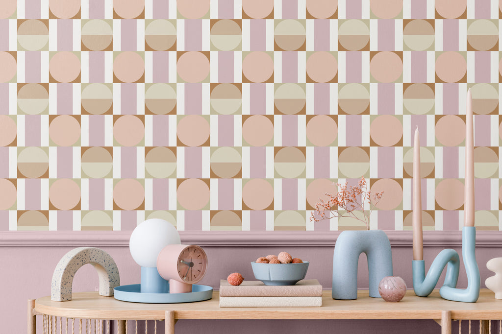 The Modernist Mosaic wallpaper in peach and rose behind a styled console