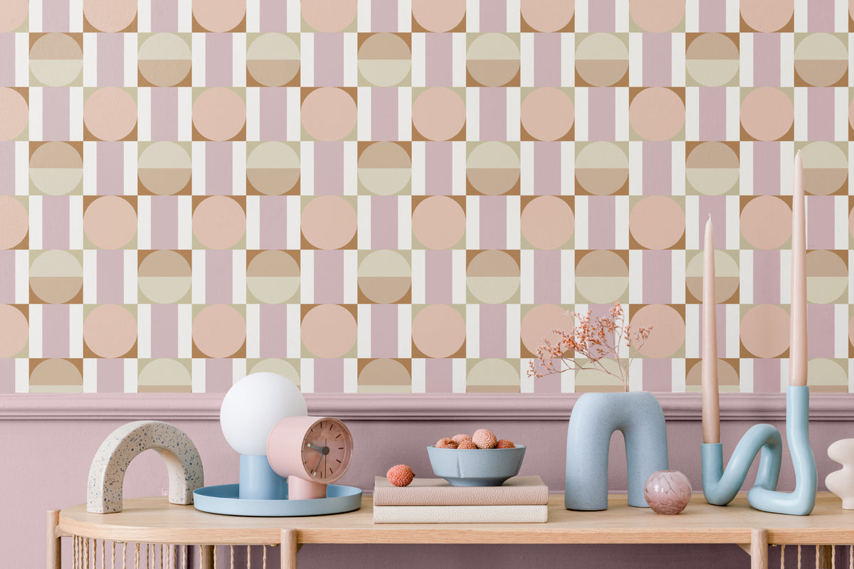The Modernist Mosaic wallpaper in peach and rose behind a styled console