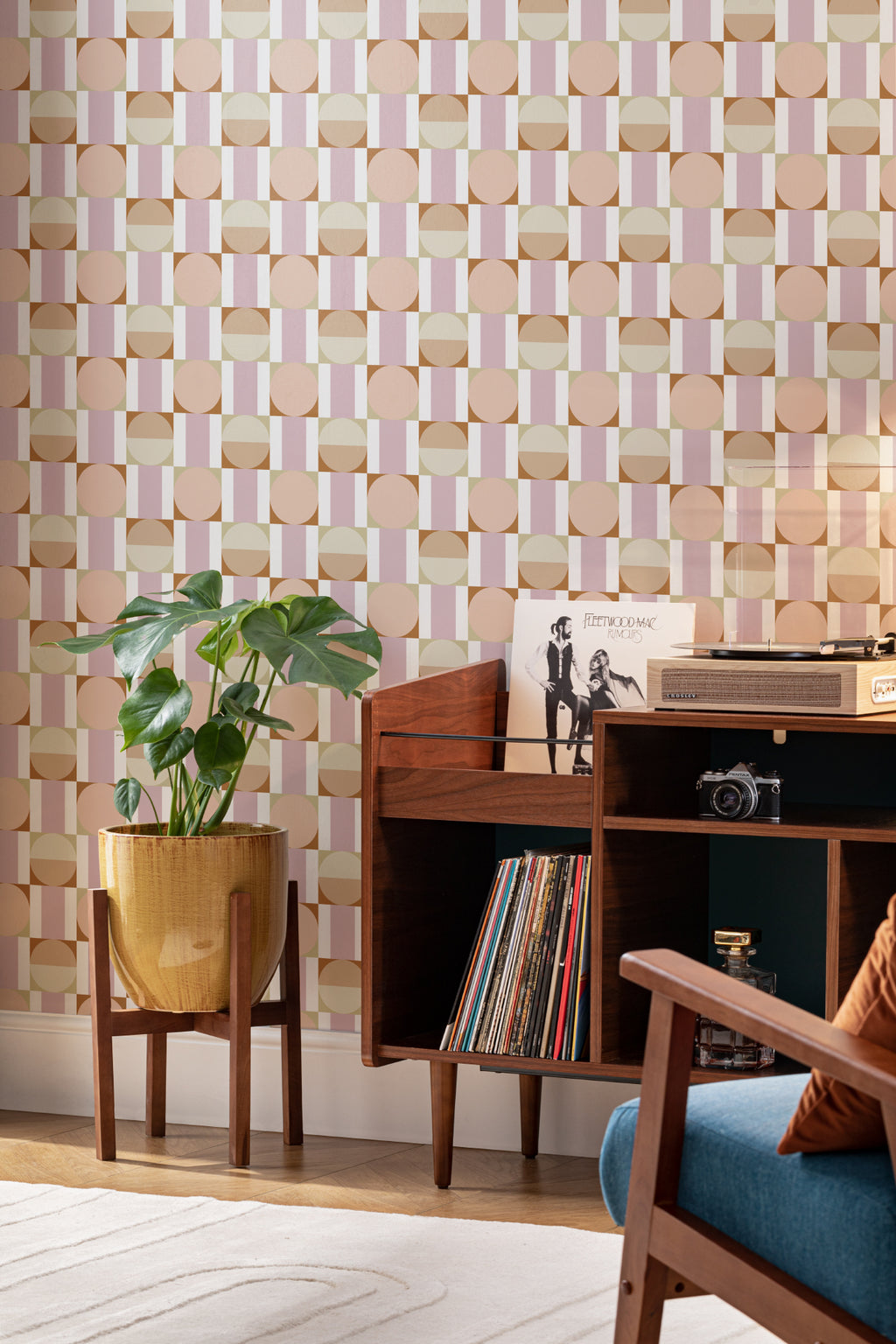 The Modernist Mosaic wallpaper in peach and rose behind a desk in a home office