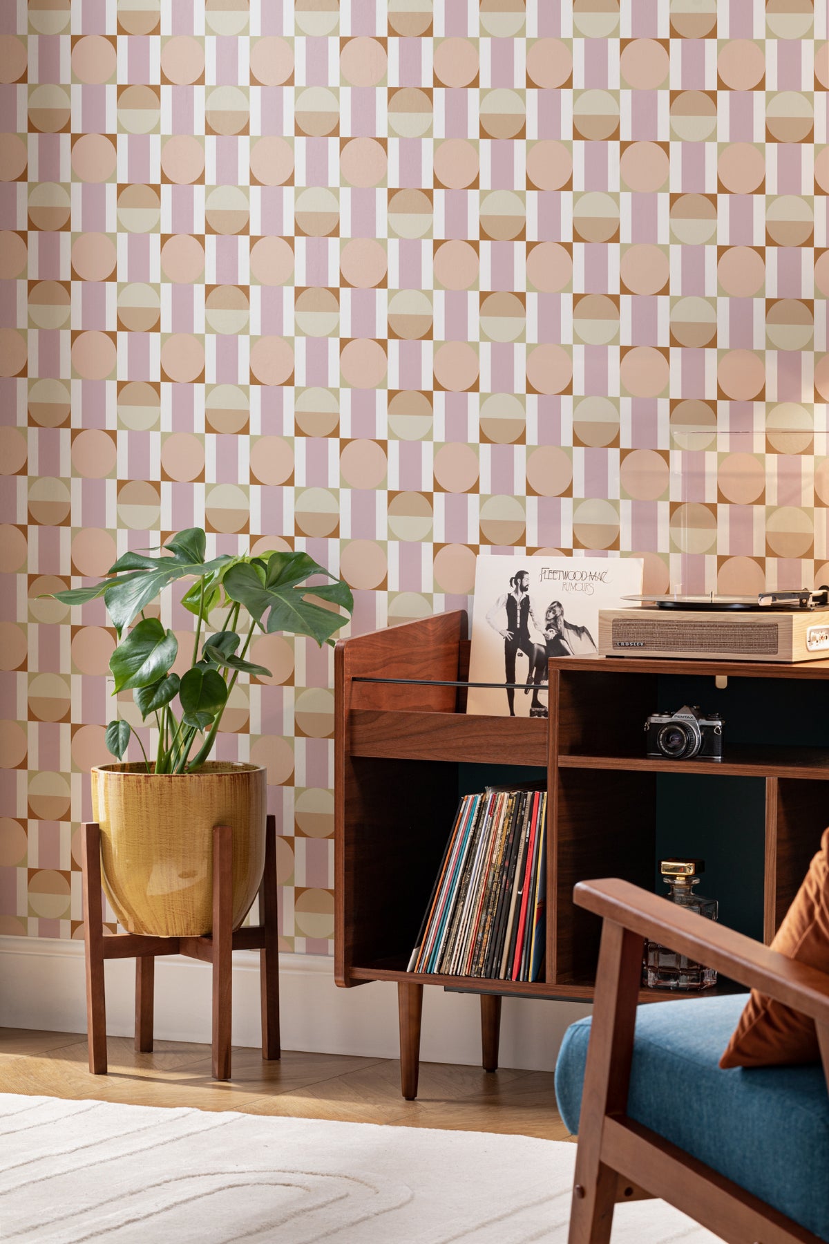 The Modernist Mosaic wallpaper in peach and rose behind a desk in a home office