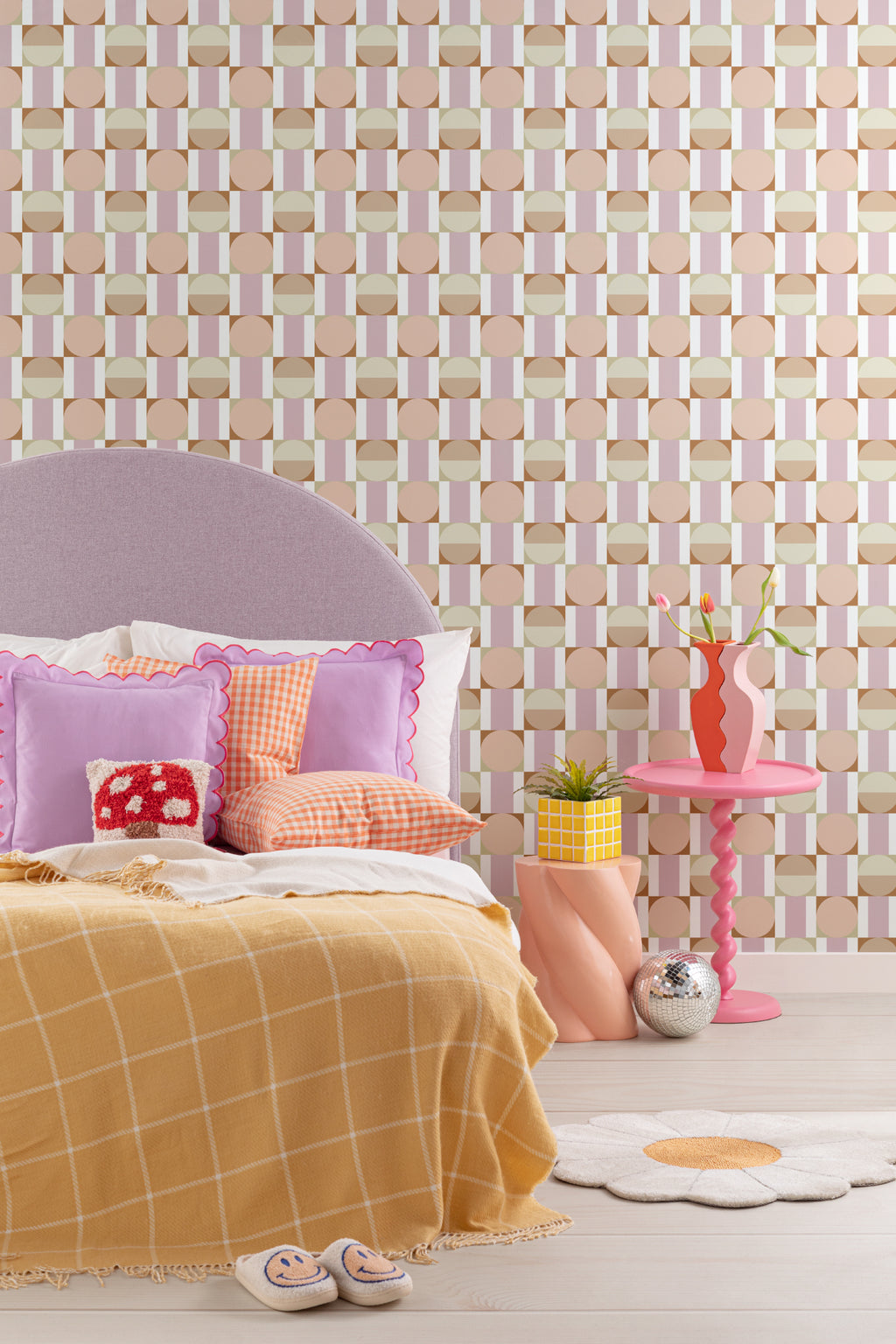 The Modernist Mosaic wallpaper in peach and rose behind a kids' play corner