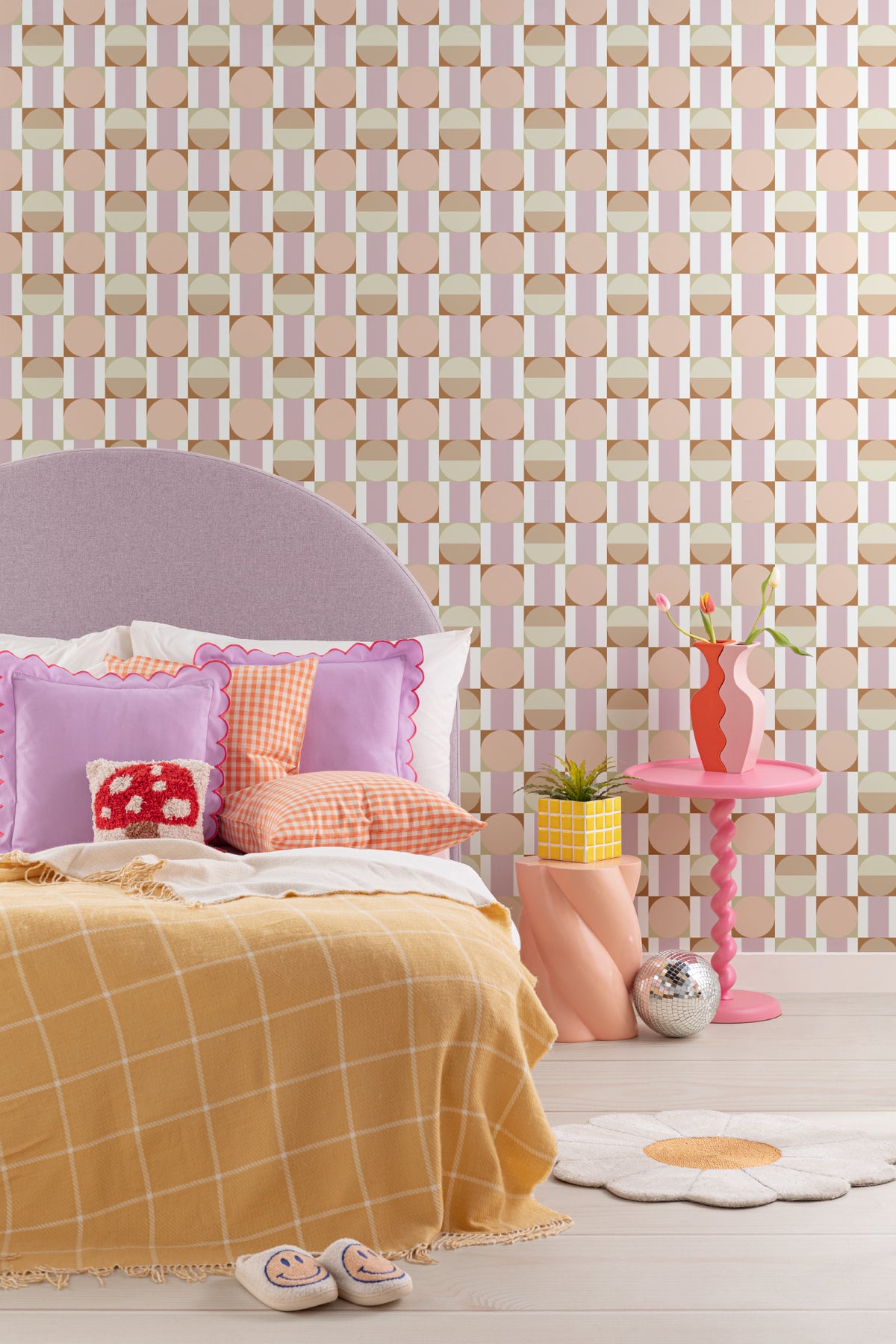 The Modernist Mosaic wallpaper in peach and rose behind a kids' play corner