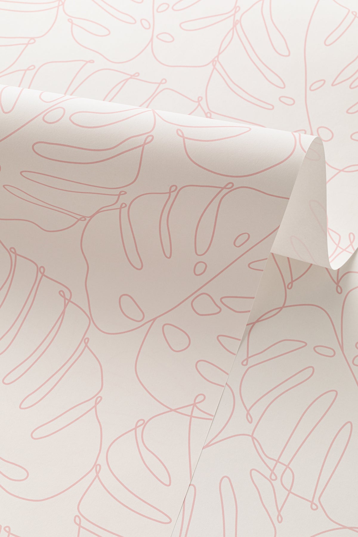 Angled detail of The Monstera Loggia wallpaper in blush and cream