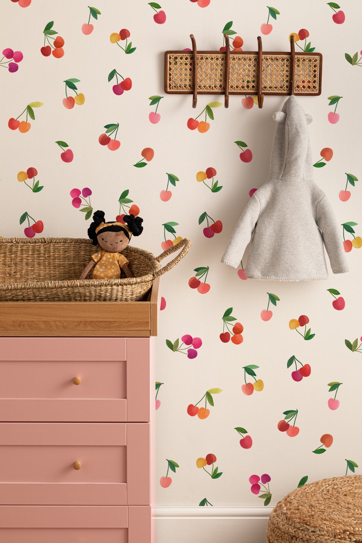The Morello Orchard wallpaper in cherry red and cream on a nursery wall