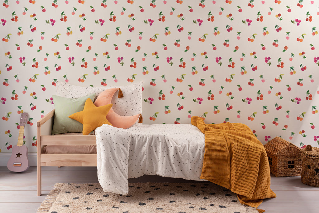 The Morello Orchard wallpaper in cherry red and cream behind the bed in a bedroom