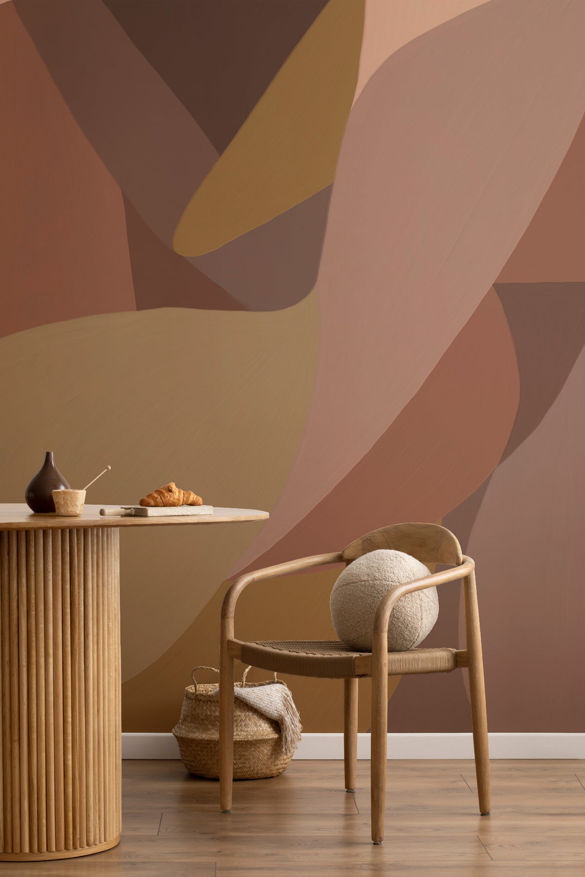 The Muse Silhouette mural in cinnamon and rose behind a styled console