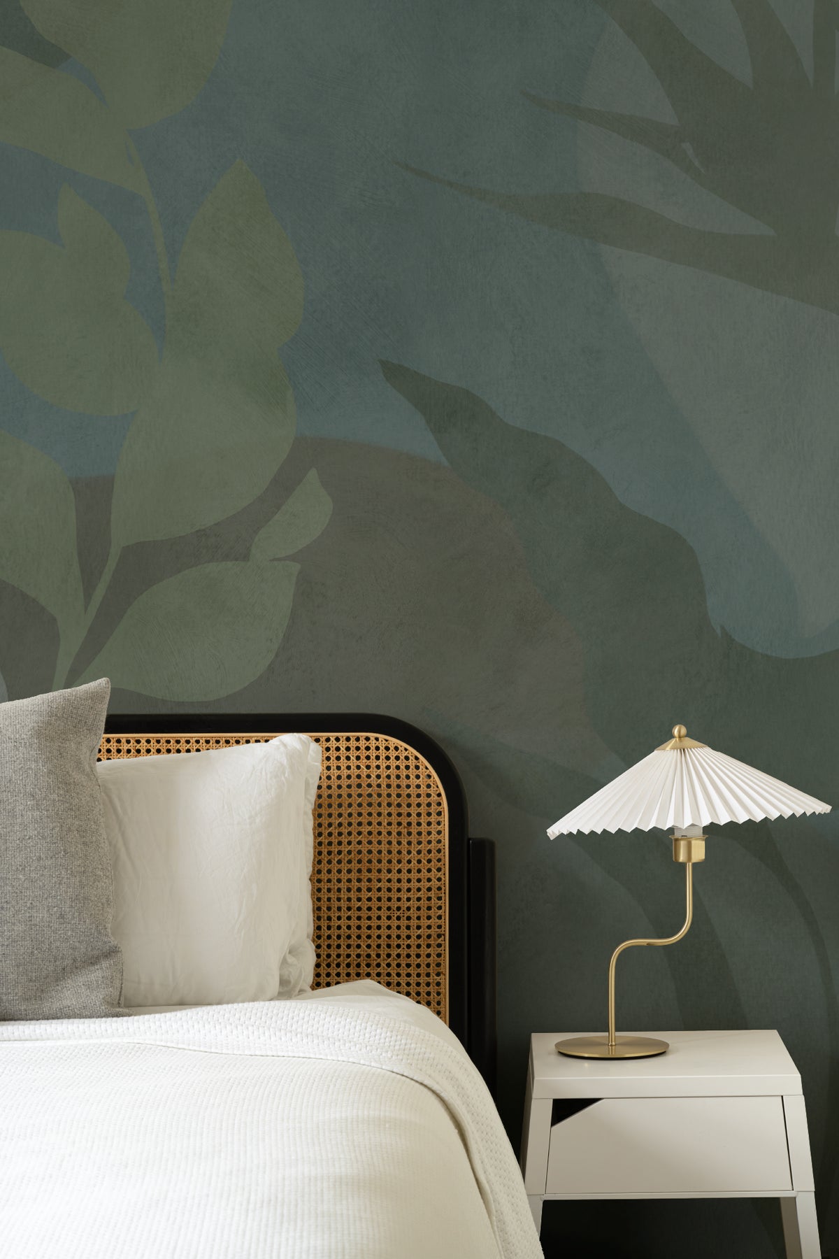 The Nocturne Fronds mural in deep teal and moss behind the bed in a bedroom