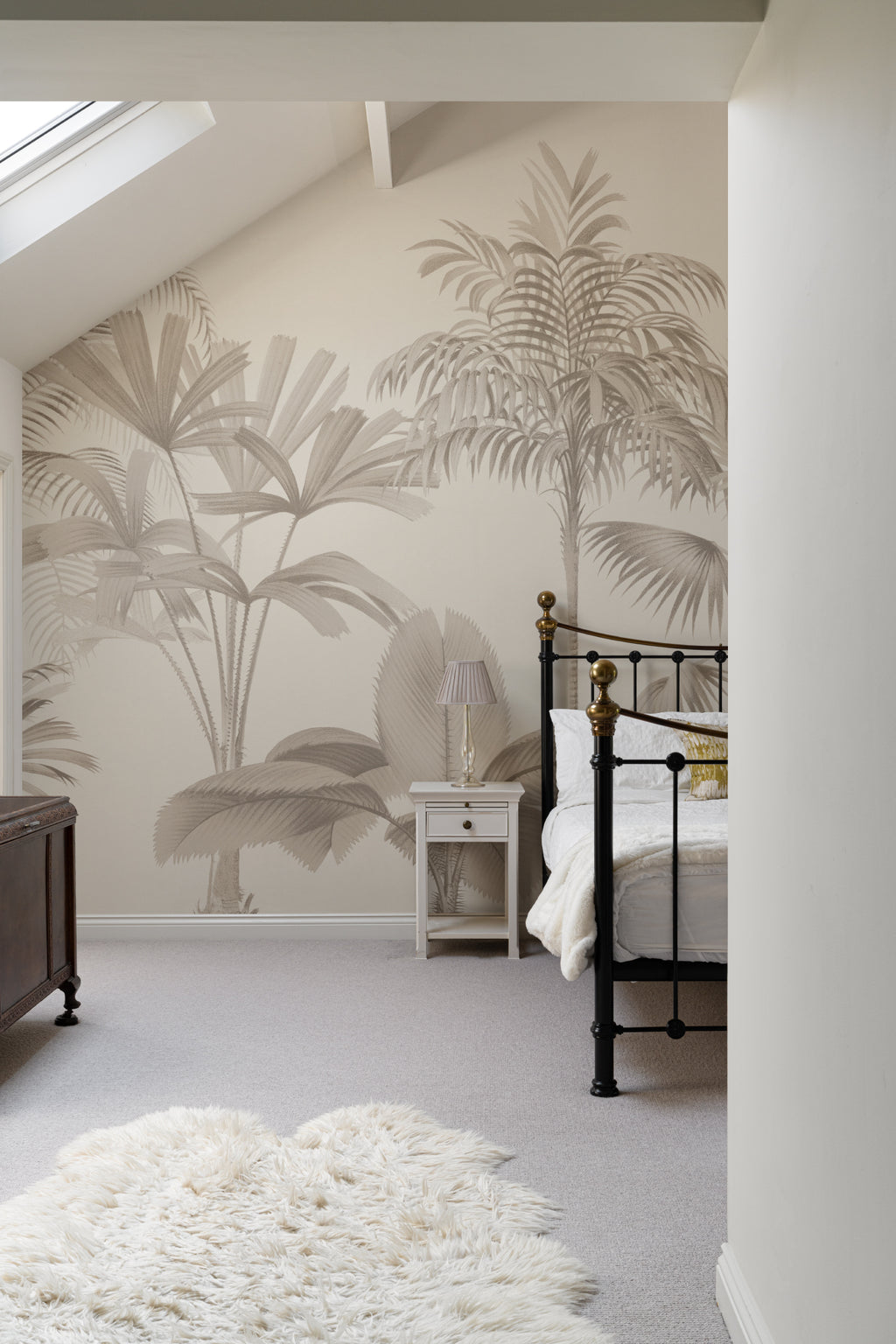 The Oasis Palms mural in sepia and sand behind seating in a living room