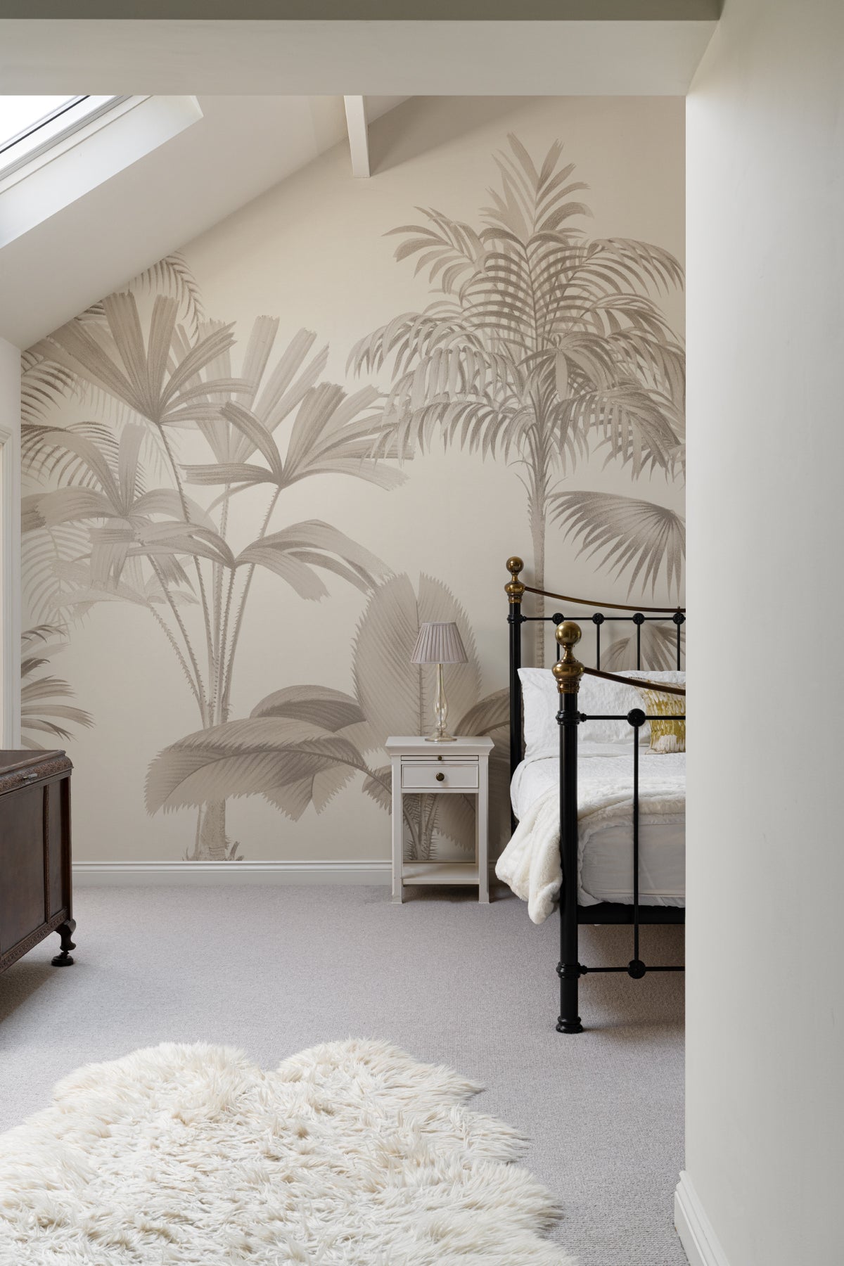 The Oasis Palms mural in sepia and sand behind seating in a living room