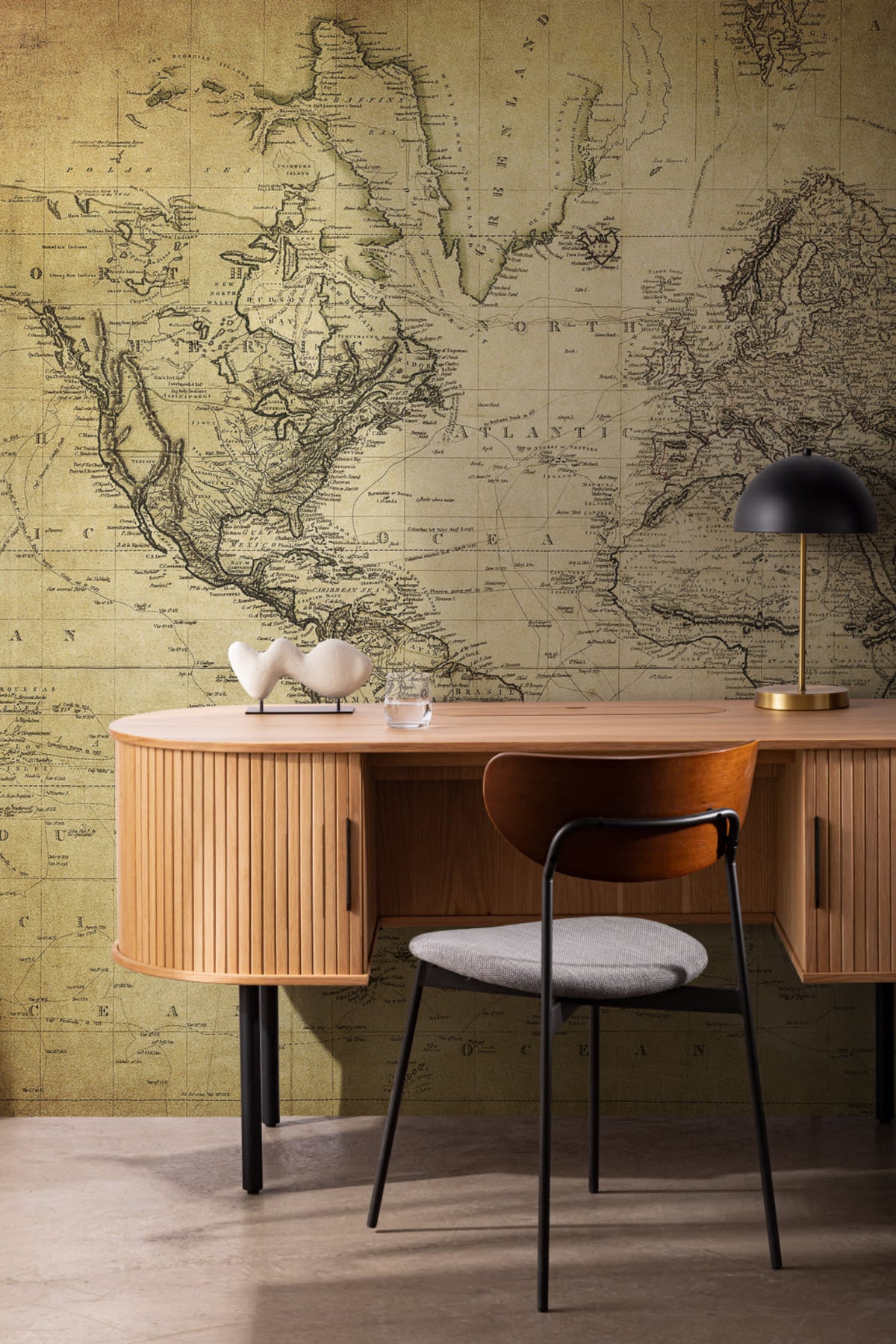The Old World Atlas mural in parchment brown in a study corner with a desk