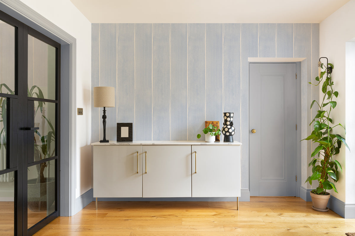 The Painted Awning wallpaper in duck egg blue in a hallway
