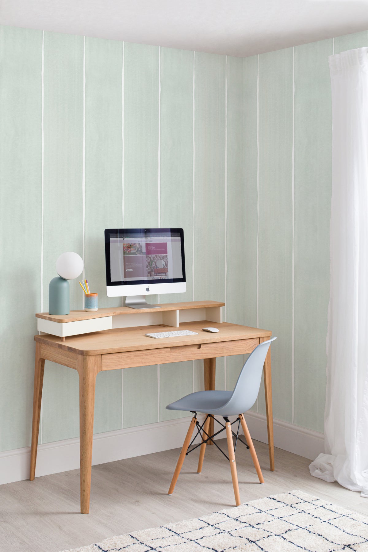 The Painted Awning wallpaper in mint sage behind a desk in a home office