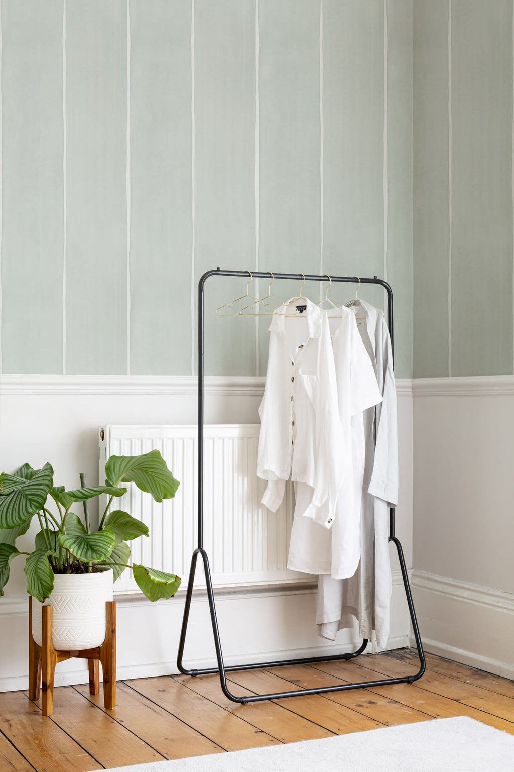 The Painted Awning wallpaper in mint sage behind a styled console