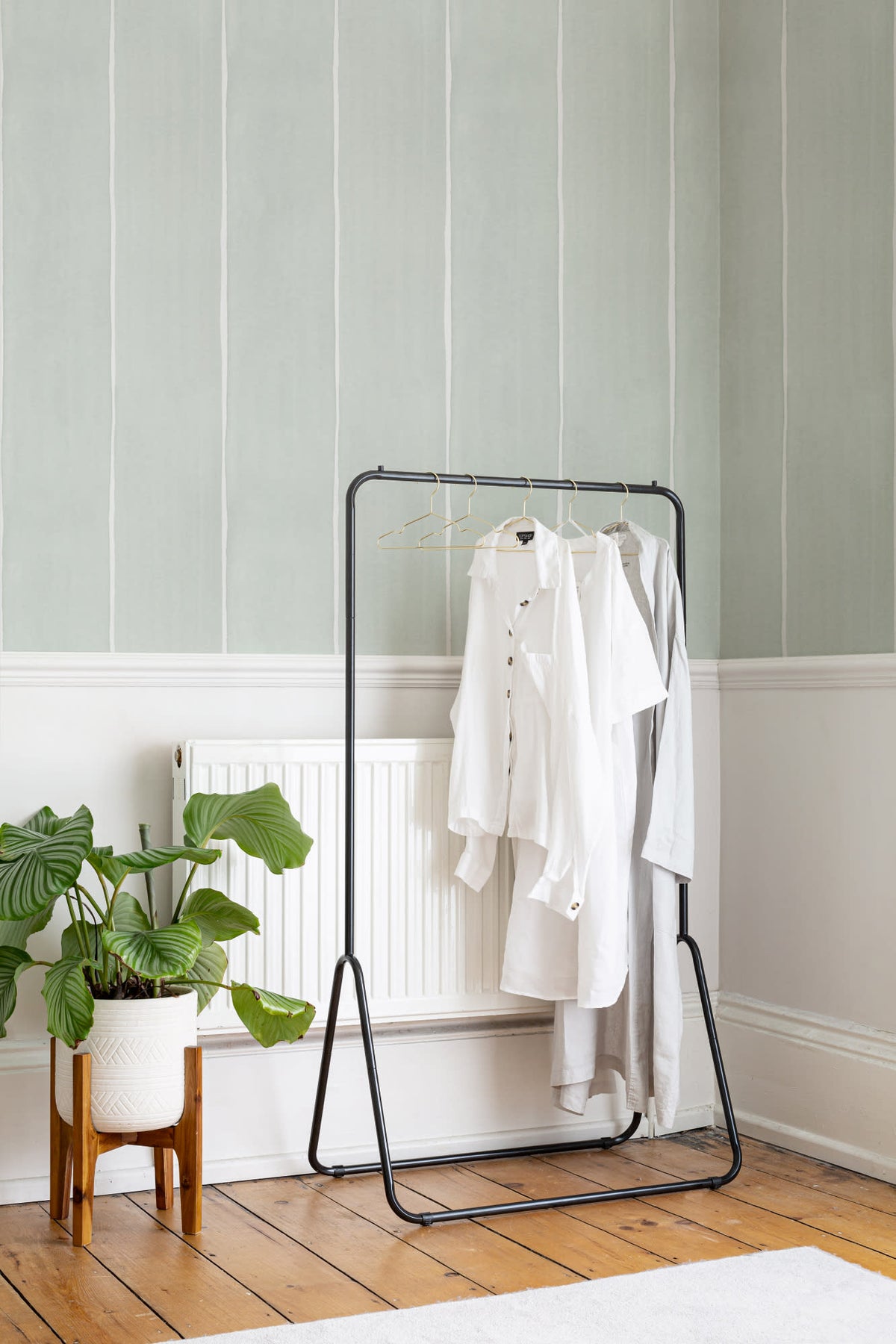 The Painted Awning wallpaper in mint sage behind a styled console