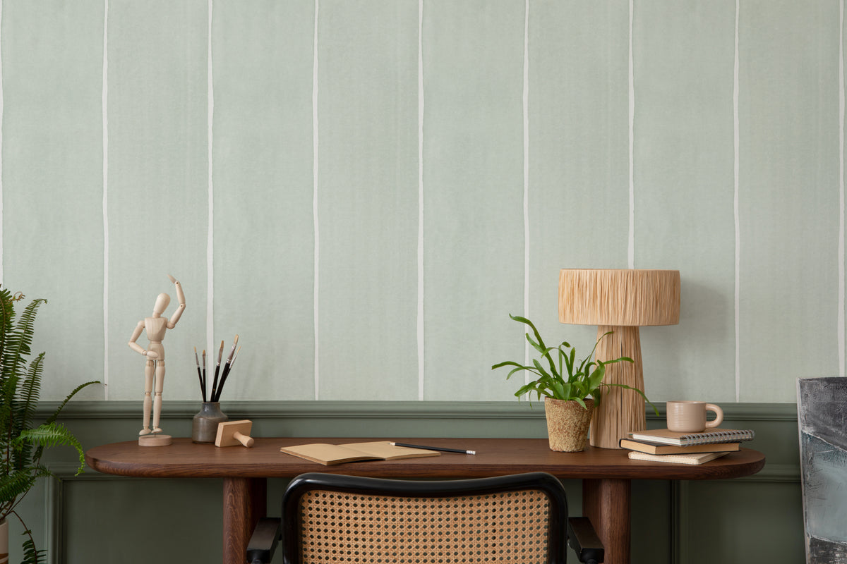 The Painted Awning wallpaper in mint sage in a study corner with a desk