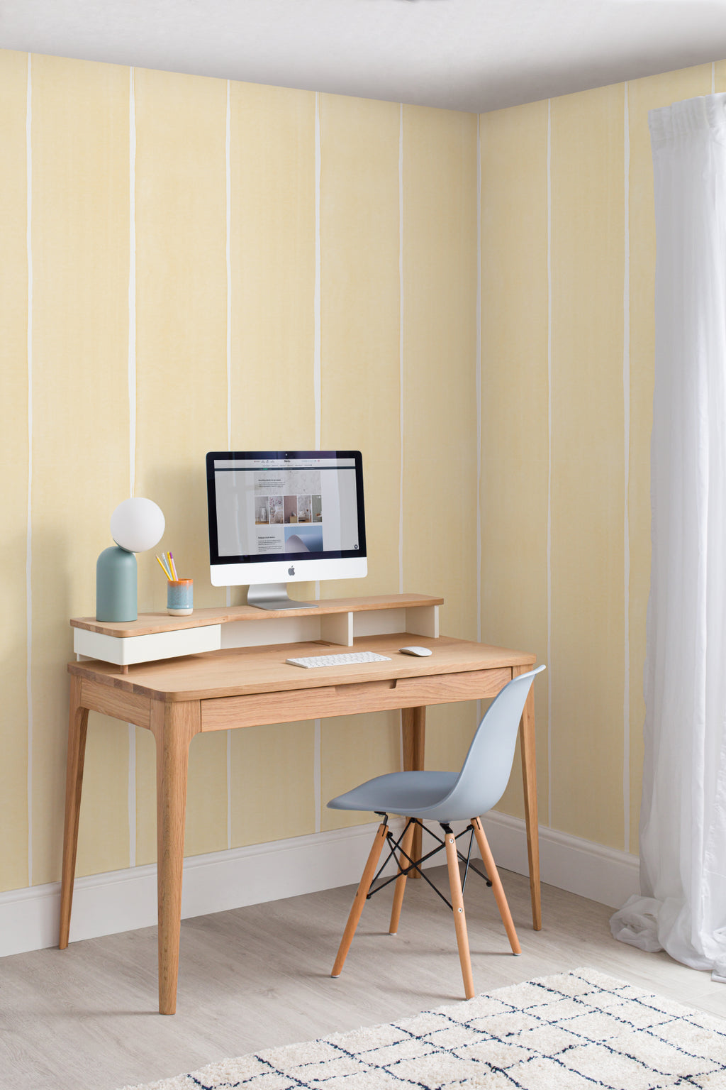 The Painted Awning wallpaper in pale primrose behind a desk in a home office