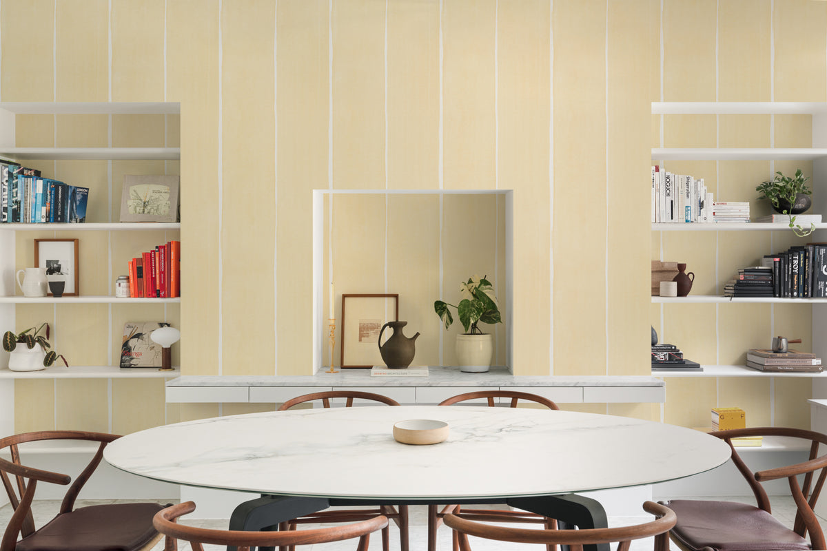 The Painted Awning wallpaper in pale primrose behind a dining table