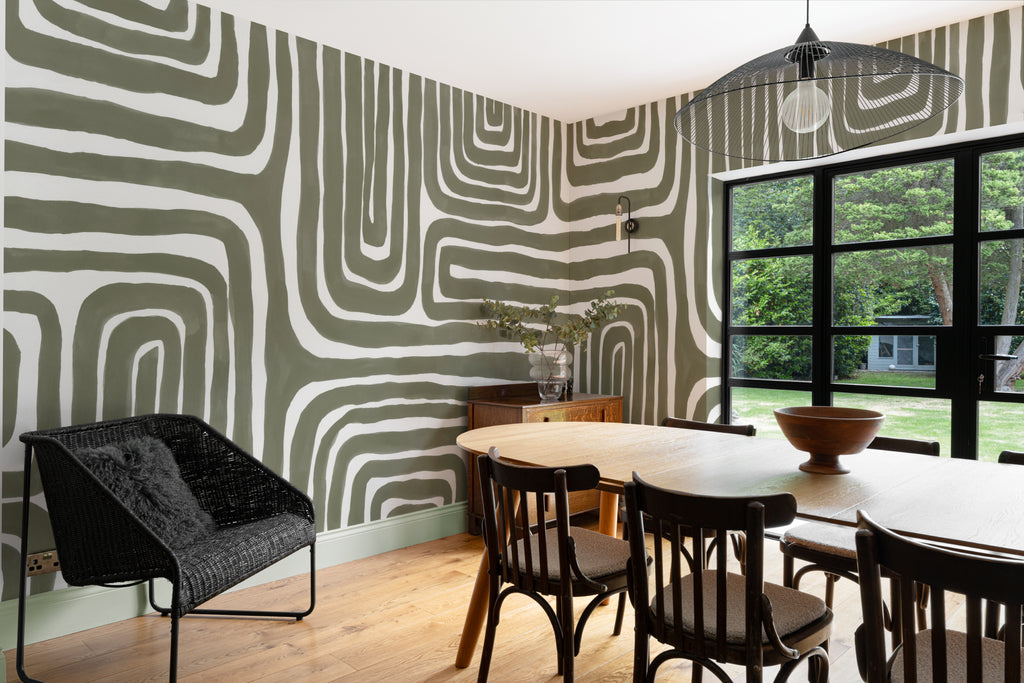 The Painted Labyrinth mural in olive and cream behind a desk in a home office