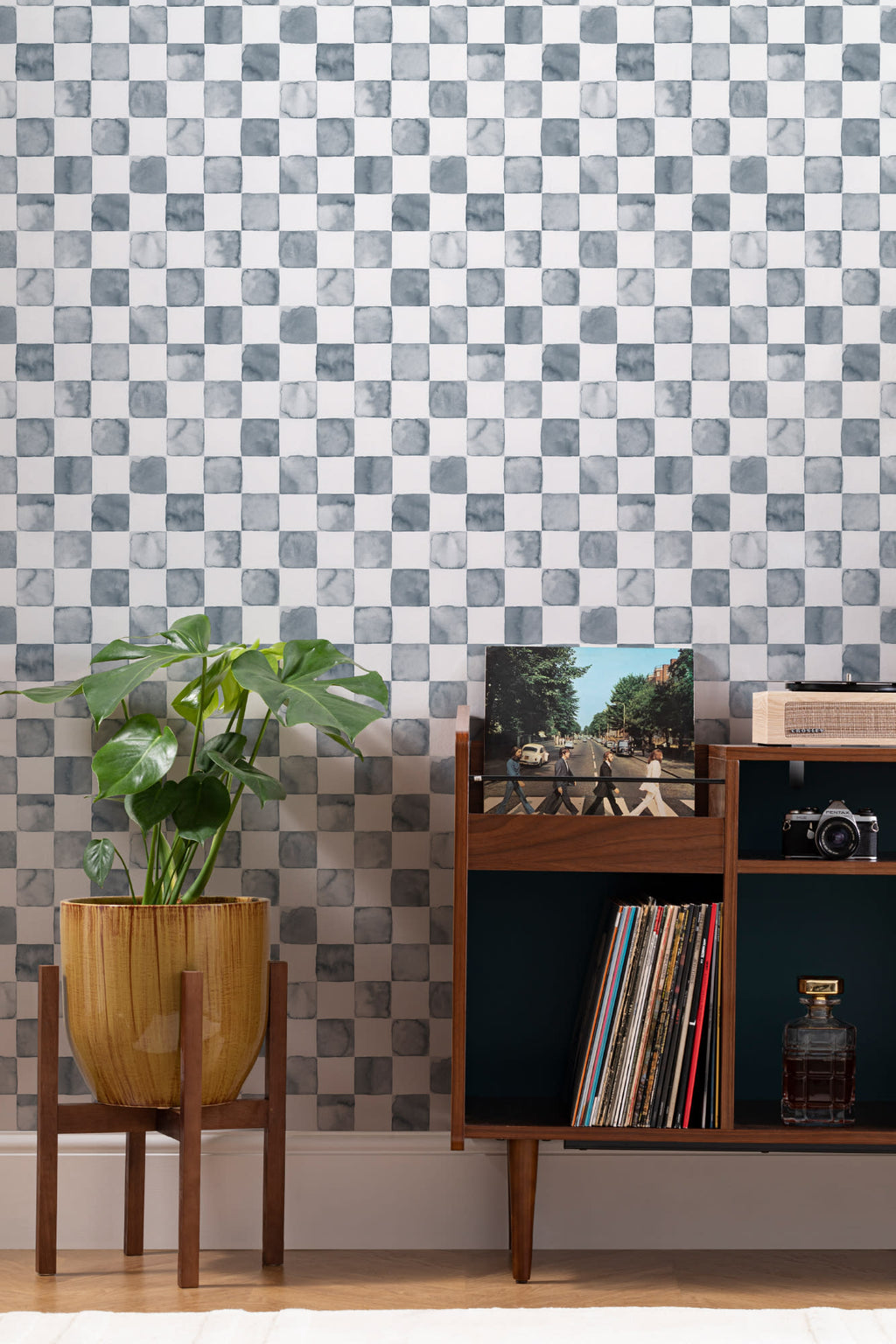 The Painted Tiling wallpaper in slate blue behind a styled console