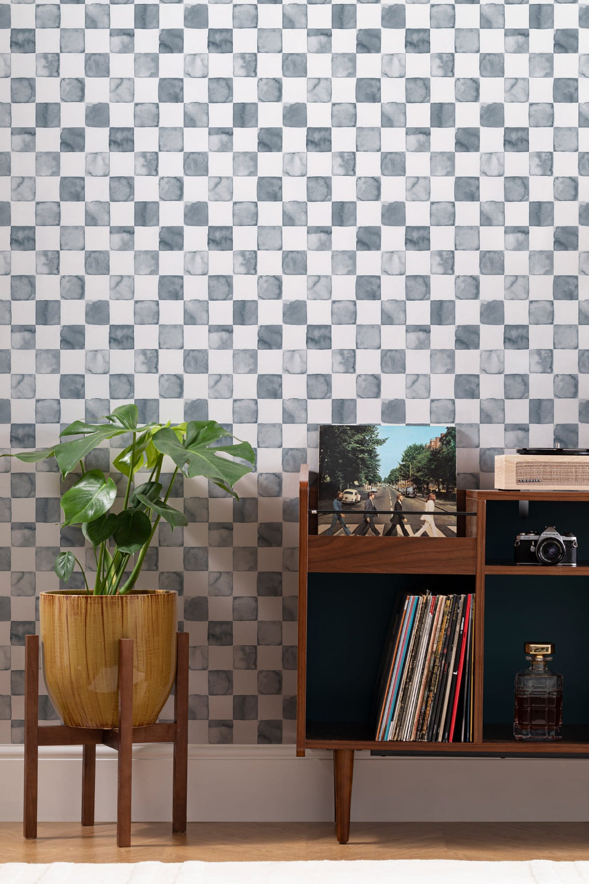 The Painted Tiling wallpaper in slate blue behind a styled console