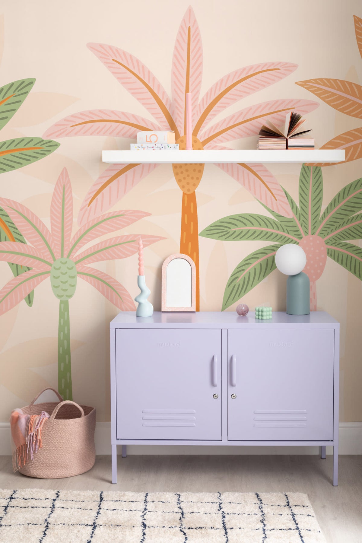 The Palm Boulevard mural in sherbet peach behind a kids' play corner