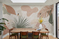 The Palm Cutout mural in clay pink and sage behind a dining table