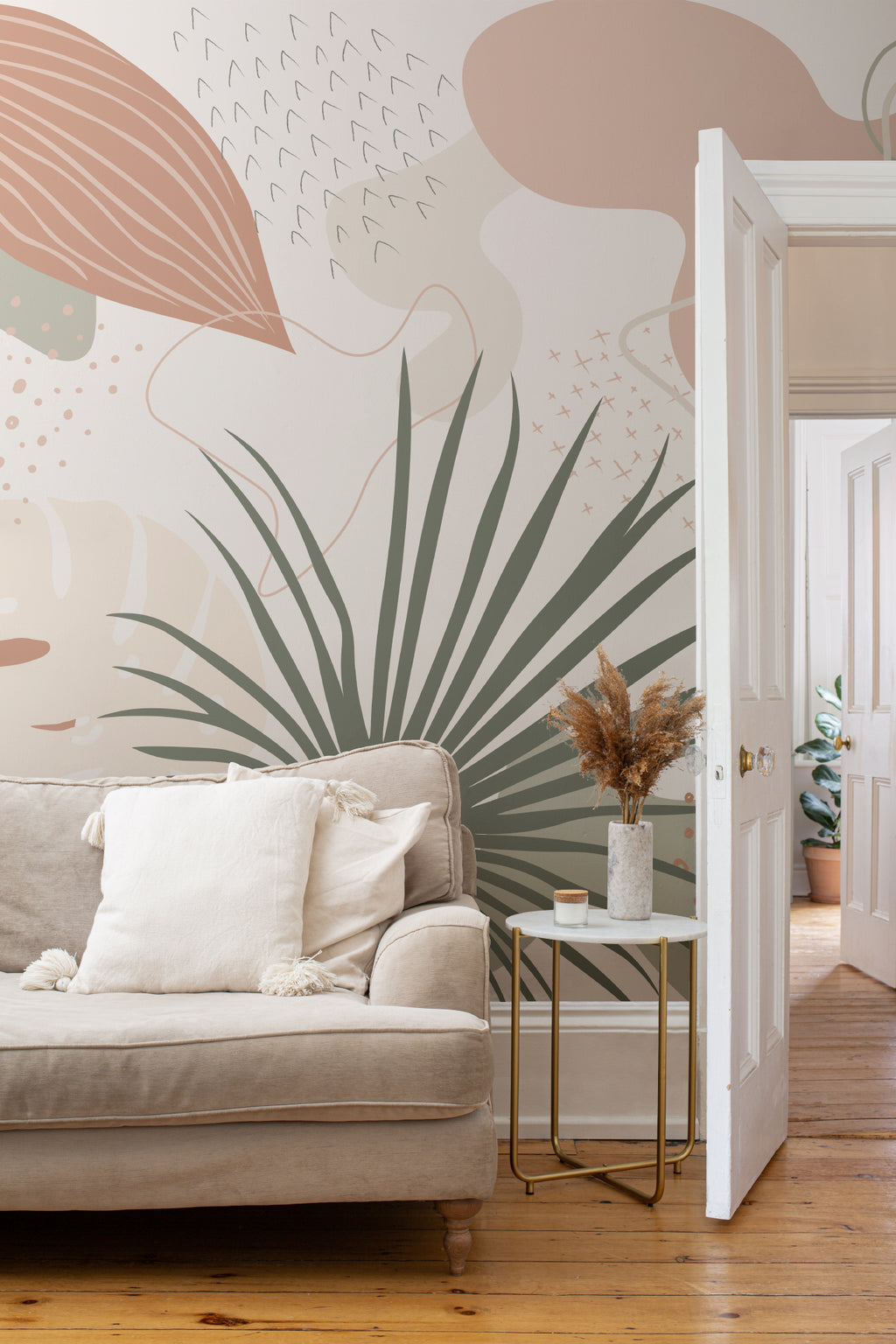 The Palm Cutout mural in clay pink and sage in a living room