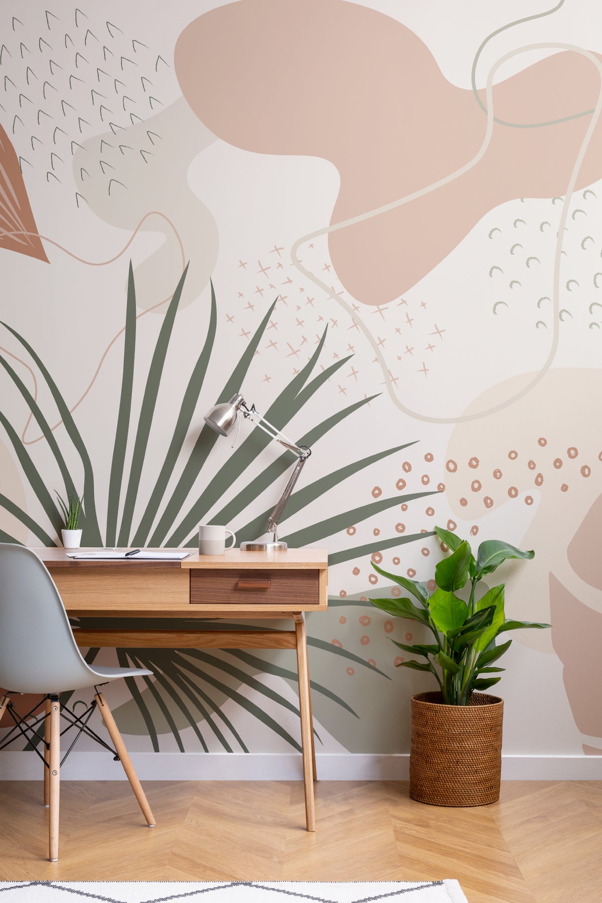 The Palm Cutout mural in clay pink and sage behind seating in a living room
