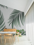 The Palm Shade mural in palm green and dove grey behind a styled console