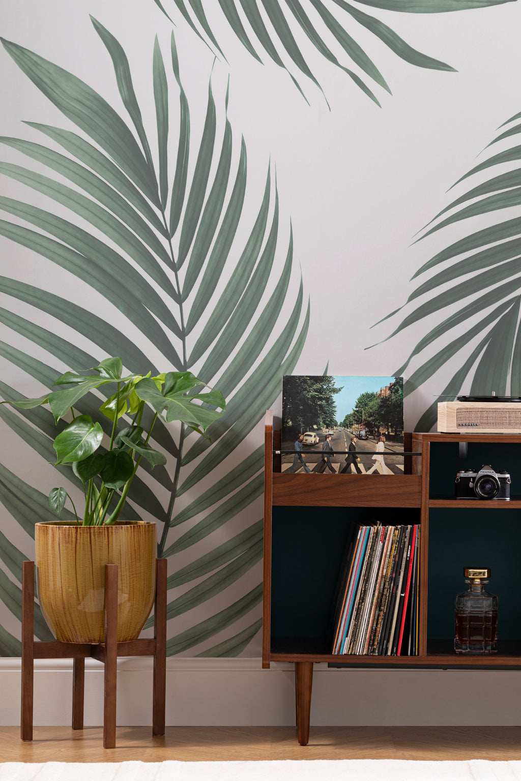 The Palm Shade mural in palm green and dove grey in a study corner with a desk