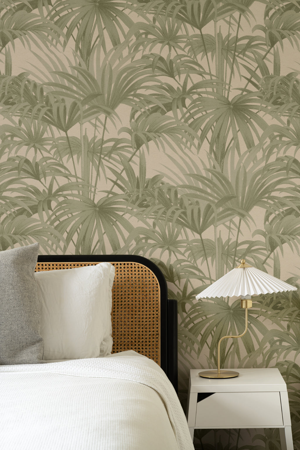 The Palmery Walk wallpaper in olive and sand behind the bed in a bedroom