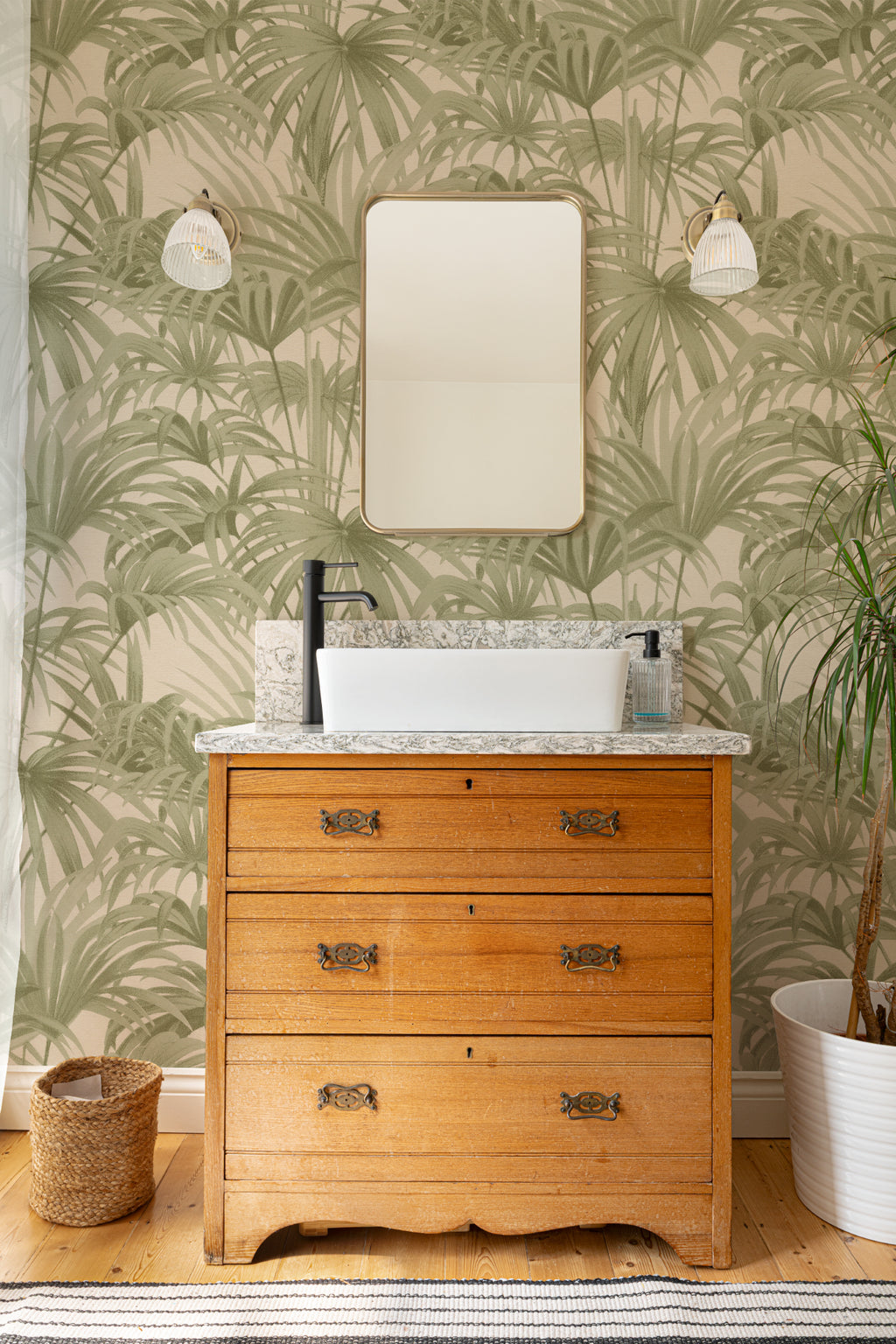 The Palmery Walk wallpaper in olive and sand behind a styled console