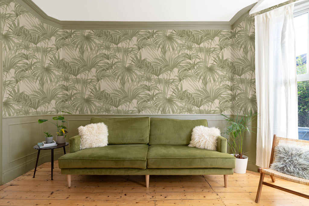 The Palmery Walk wallpaper in olive and sand in a living room