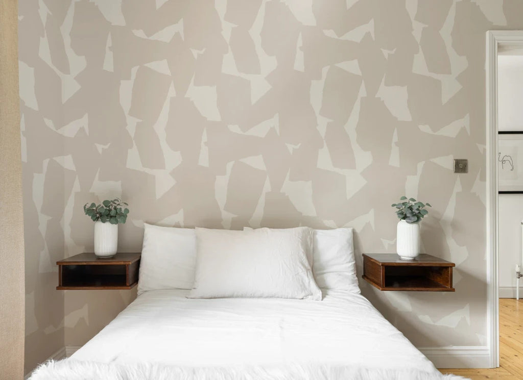The Paper Mosaic wallpaper in oat beige behind the bed in a bedroom