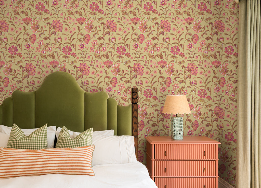 The Pavilion Garland wallpaper in antique gold behind the bed in a bedroom