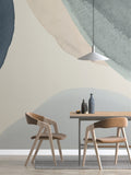 The Pebble Wash mural in denim and sand behind a dining table